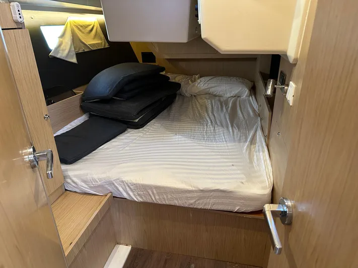  Yacht Photos Pics Cozy cabin interior of 2017 Beneteau Oceanis 41.1 sailboat with bed and wooden finish.
