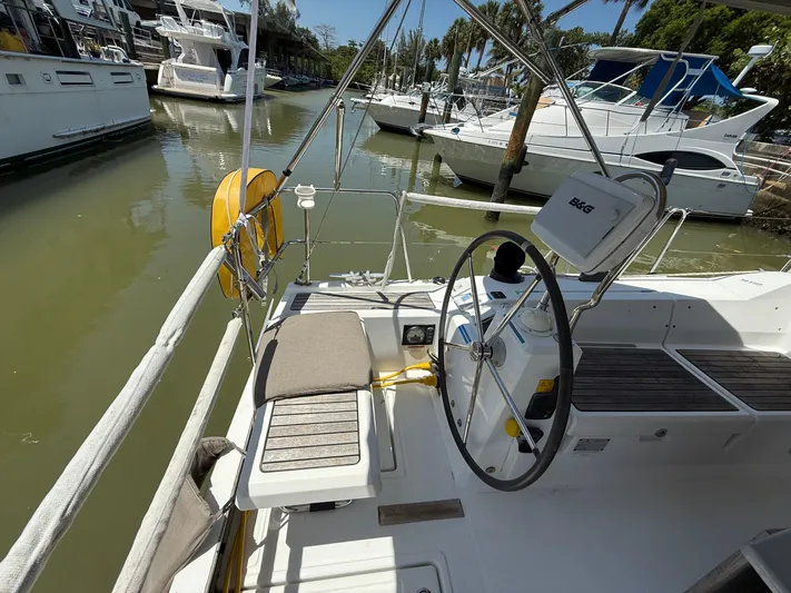  Yacht Photos Pics 2017 Beneteau Oceanis 41.1 sailboat cockpit with steering wheel, docked in marina.