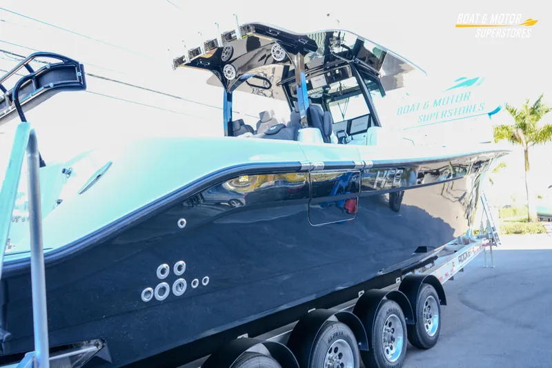  Yacht Photos Pics 2023 HCB 39 Speciale boat on trailer at dealership, showcasing sleek design.