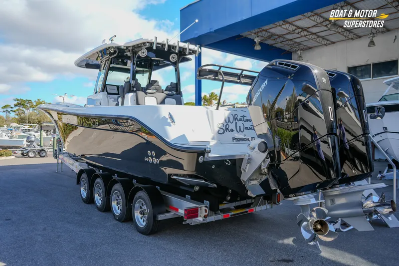  Yacht Photos Pics 2023 HCB 39 Speciale boat with dual Mercury engines on a trailer at a dealership.