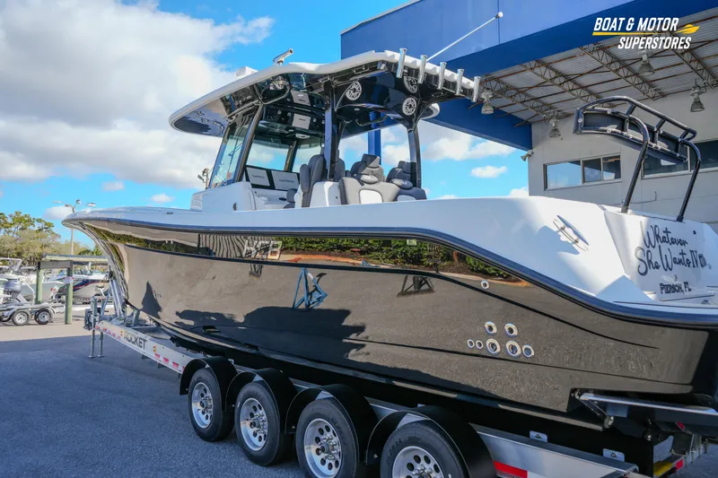  Yacht Photos Pics 2023 HCB 39 Speciale boat on trailer at dealership under blue sky.