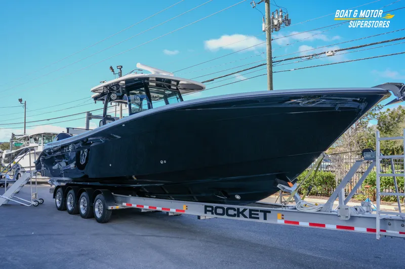  Yacht Photos Pics 2023 HCB 39 Speciale boat on trailer at dealership, clear sky background.
