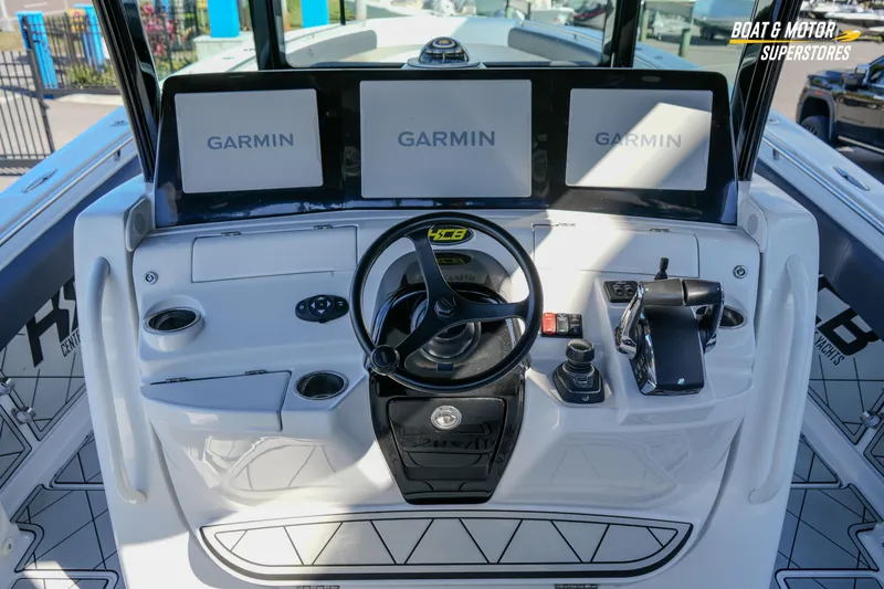  Yacht Photos Pics 2023 HCB 39 Speciale boat dashboard with Garmin navigation screens and steering wheel.