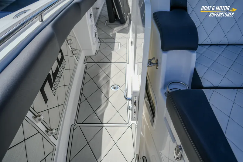  Yacht Photos Pics 2023 HCB 39 Speciale boat interior with diamond-patterned flooring and cushioned seating.
