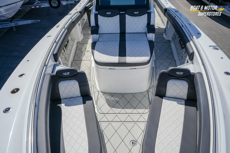  Yacht Photos Pics 2023 HCB 39 Speciale boat interior with luxurious seating and diamond-patterned upholstery.