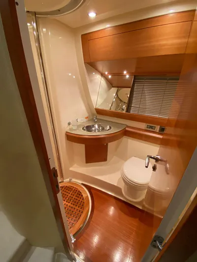  Yacht Photos Pics Luxurious bathroom in 2006 Azimut 50 yacht with modern fixtures and wooden accents.