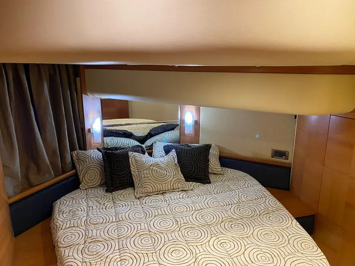  Yacht Photos Pics Luxurious bedroom interior of 2006 Azimut 50 yacht with patterned bedding and ambient lighting.