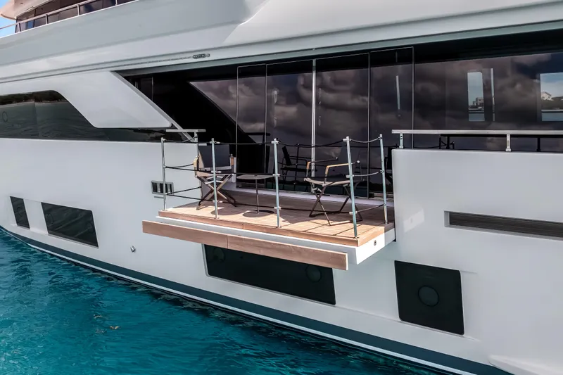 Navetta Yacht Photos Pics Luxury yacht Custom Line NAVETTA 42, 2023 model, featuring a sleek balcony over turquoise water.