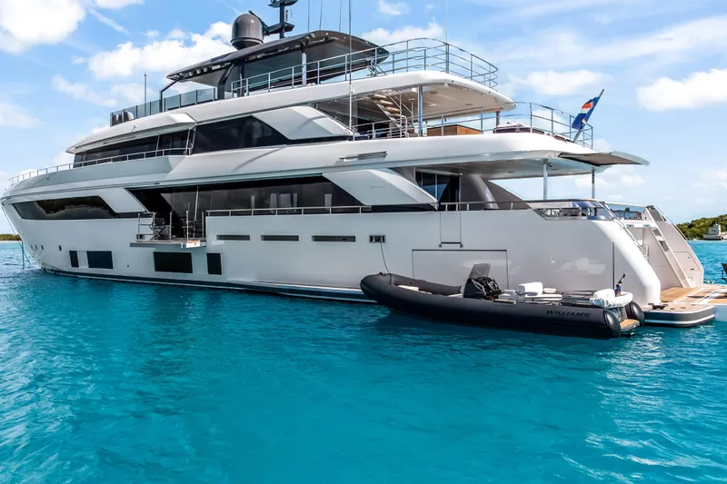 Navetta Yacht Photos Pics Luxurious 2023 Custom Line NAVETTA 42 yacht on clear blue water, featuring sleek design and modern amenities.