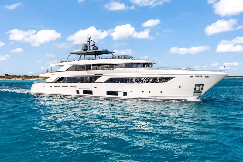 Navetta Yacht Photos Pics Luxurious 2023 Custom Line NAVETTA 42 yacht cruising on clear blue waters.