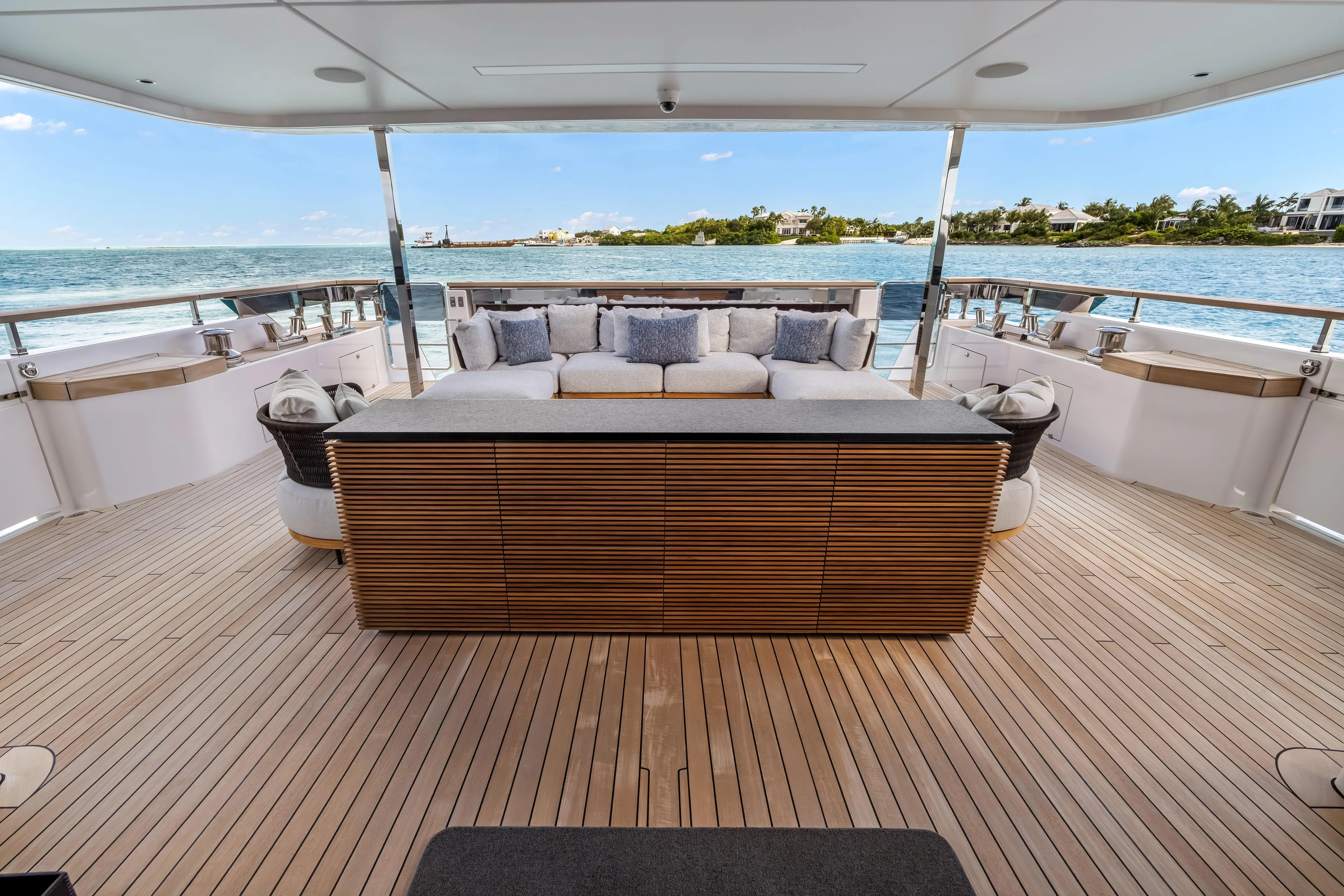 Navetta Yacht Photos Pics Luxurious 2023 Custom Line NAVETTA 42 yacht deck with elegant seating and ocean view.