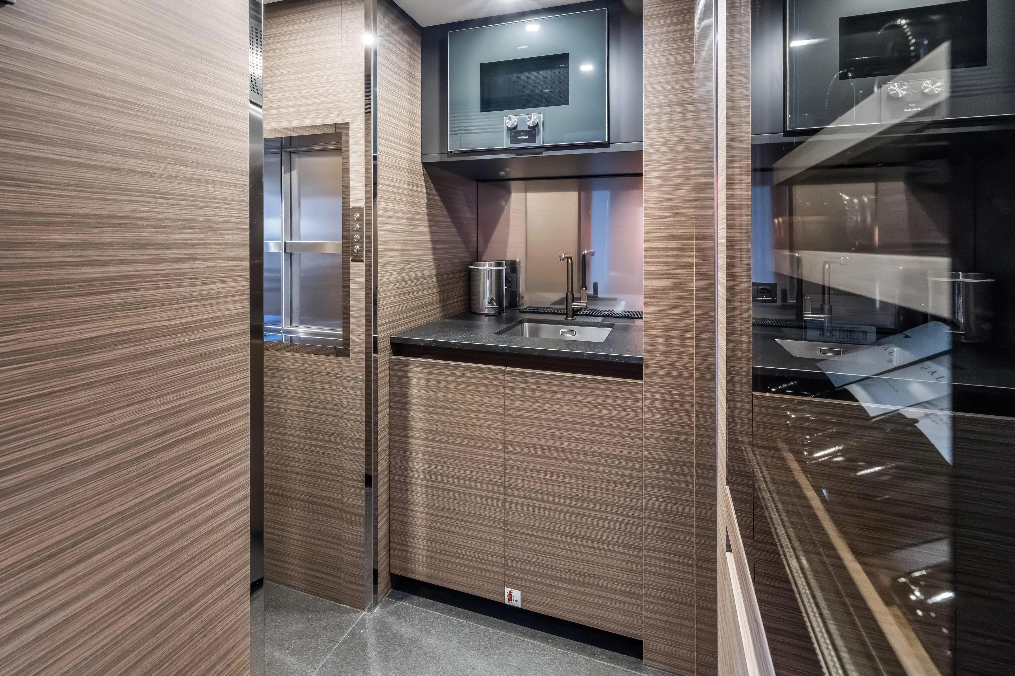 Navetta Yacht Photos Pics Luxurious 2023 Custom Line NAVETTA 42 yacht kitchen with modern wood finish and sleek appliances.