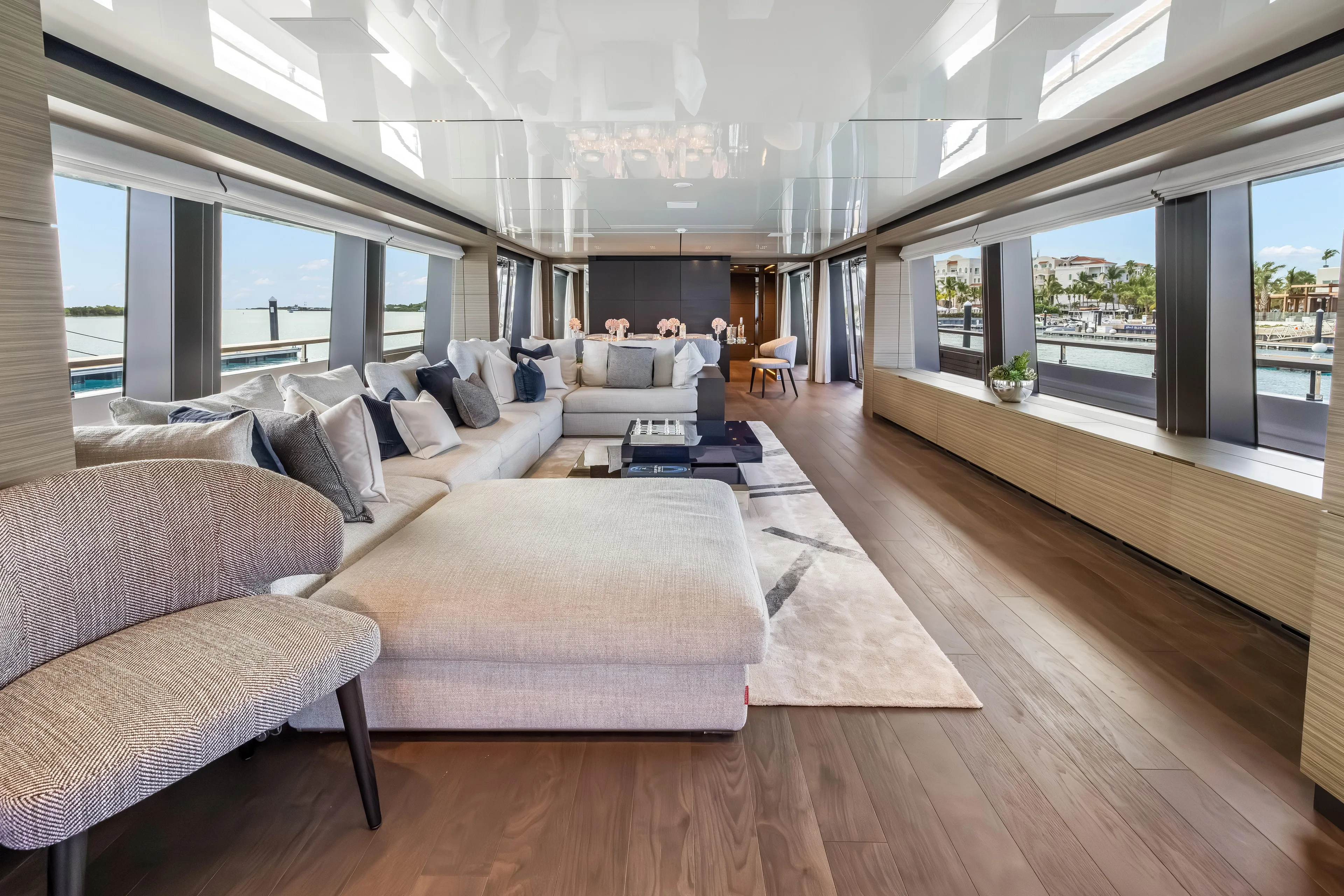 Navetta Yacht Photos Pics Luxurious interior of 2023 Custom Line NAVETTA 42 yacht with elegant seating and panoramic windows.
