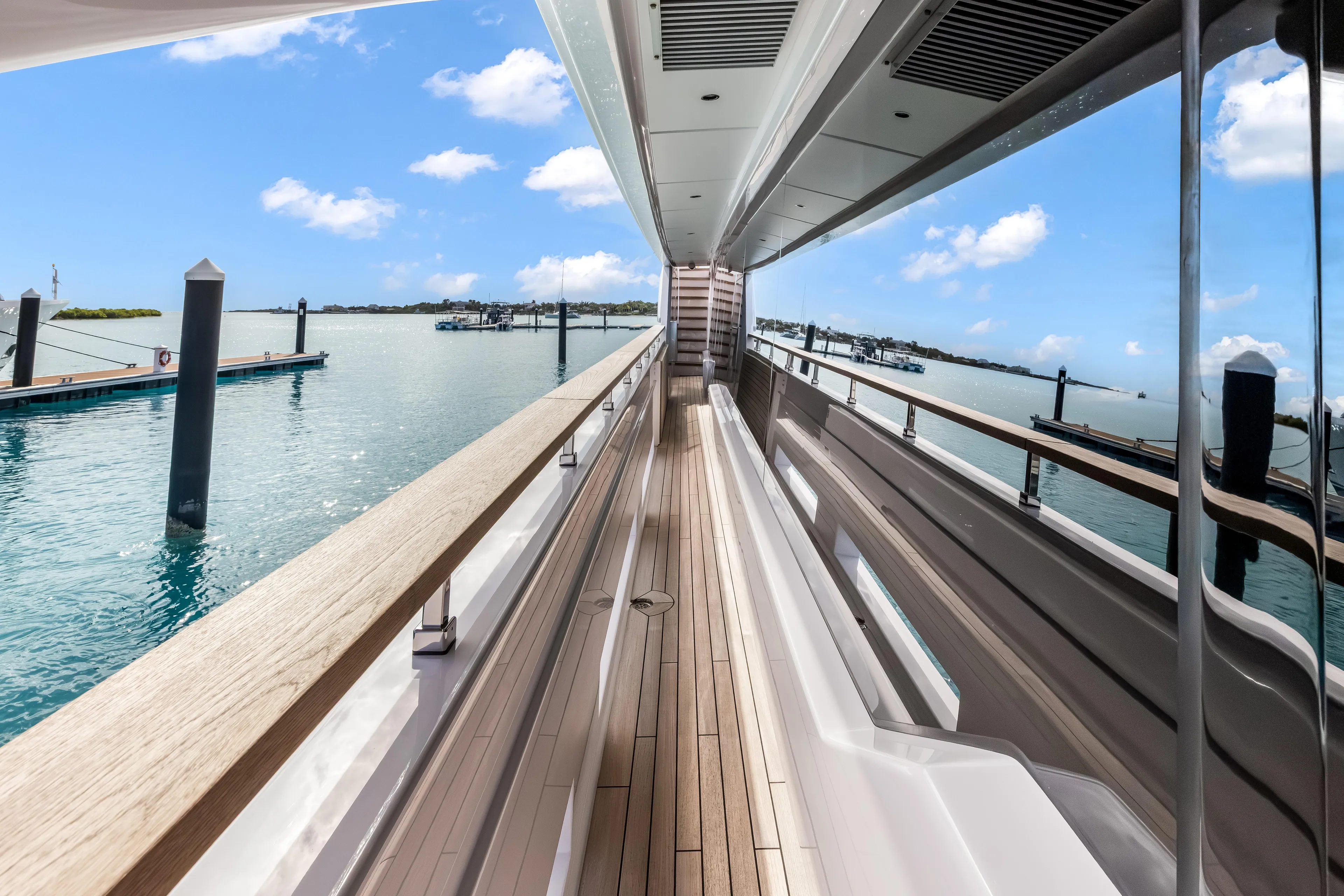 Navetta Yacht Photos Pics Custom Line NAVETTA 42 yacht deck, 2023 model, with ocean view and clear blue sky.