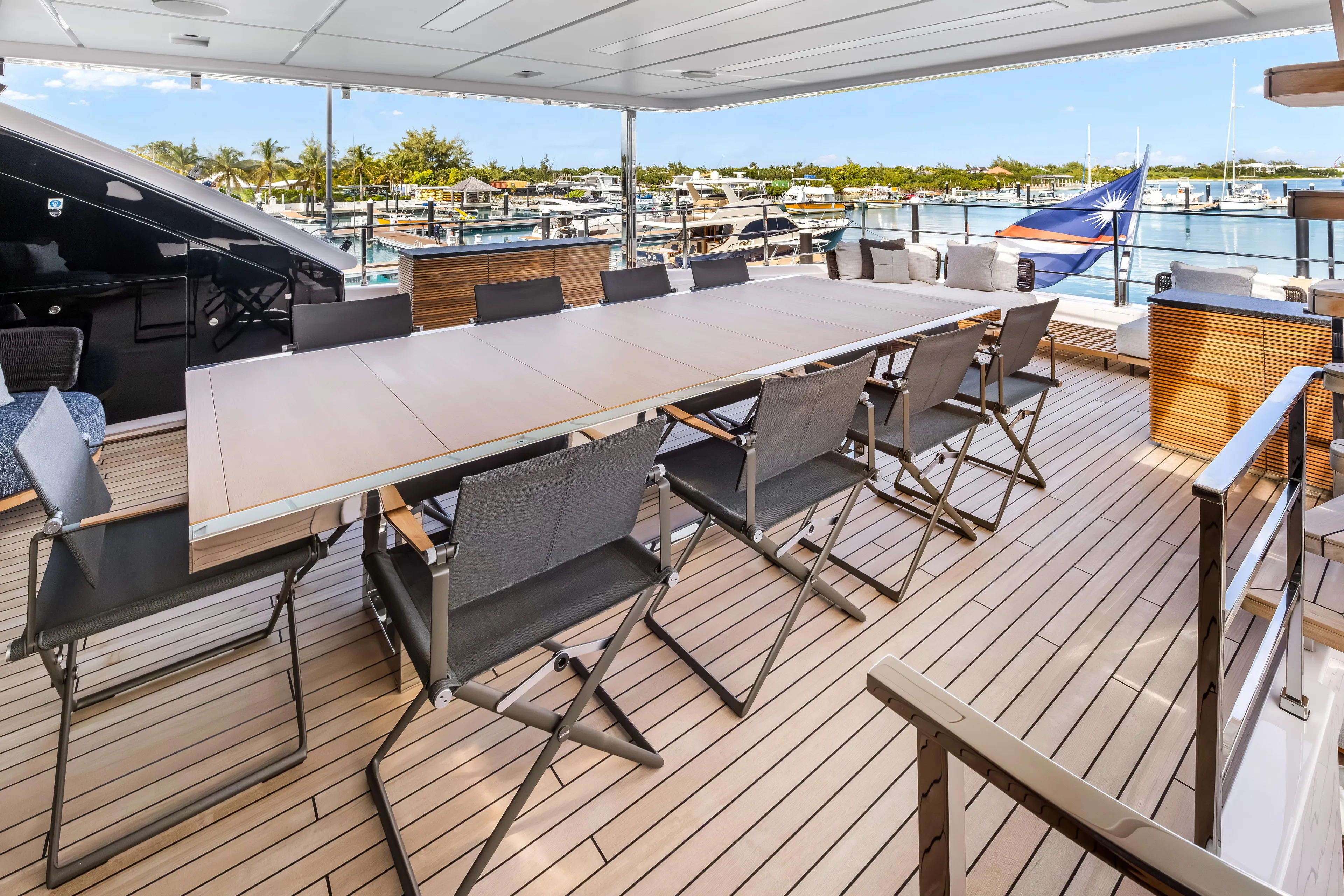 Navetta Yacht Photos Pics Luxurious 2023 Custom Line NAVETTA 42 yacht deck with elegant dining area.