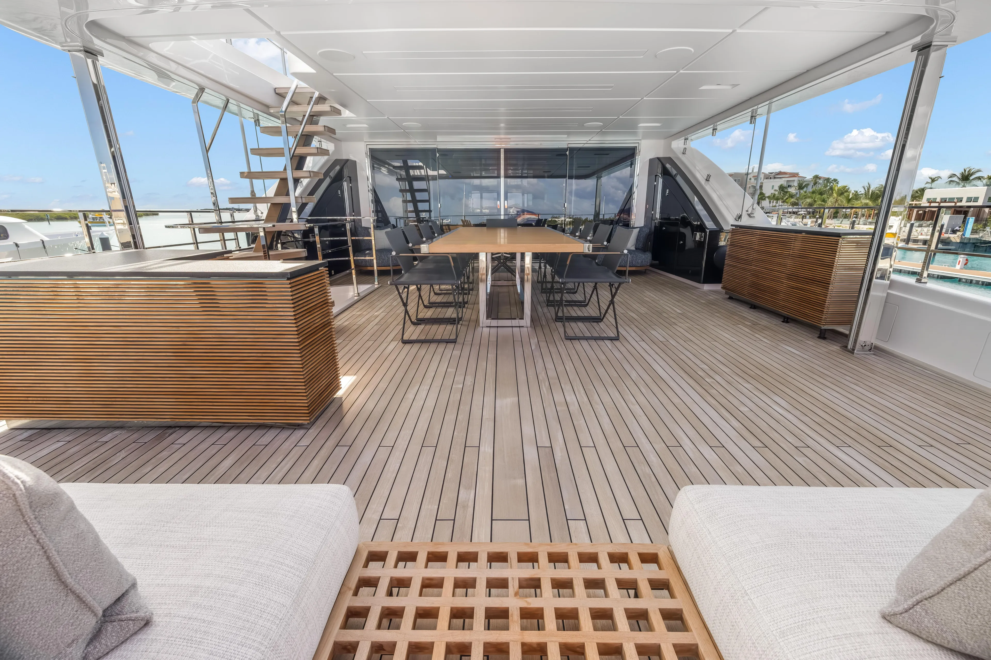 Navetta Yacht Photos Pics Luxurious 2023 Custom Line NAVETTA 42 yacht deck with elegant seating and dining area.