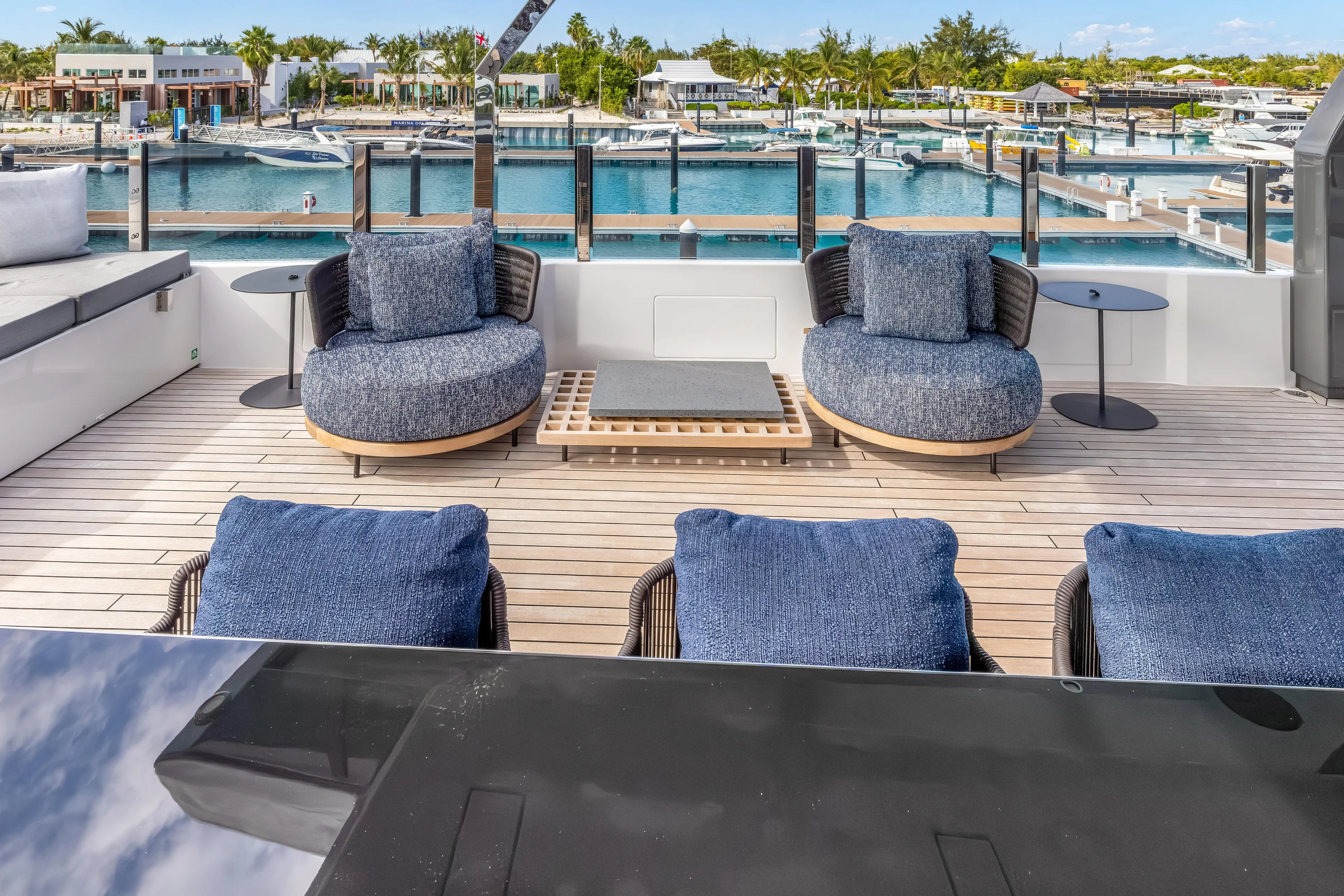 Navetta Yacht Photos Pics Luxurious deck of 2023 Custom Line NAVETTA 42 yacht with plush seating and marina view.