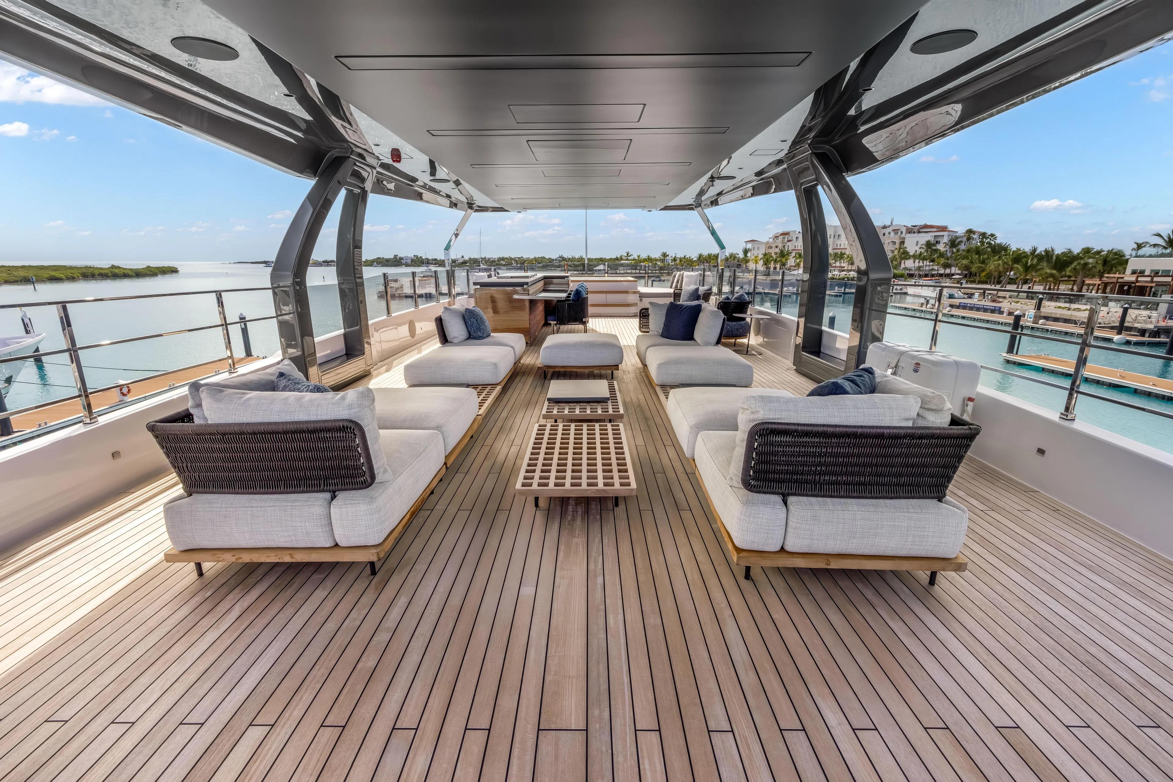 Navetta Yacht Photos Pics Luxurious 2023 Custom Line NAVETTA 42 yacht deck with elegant seating and ocean view.