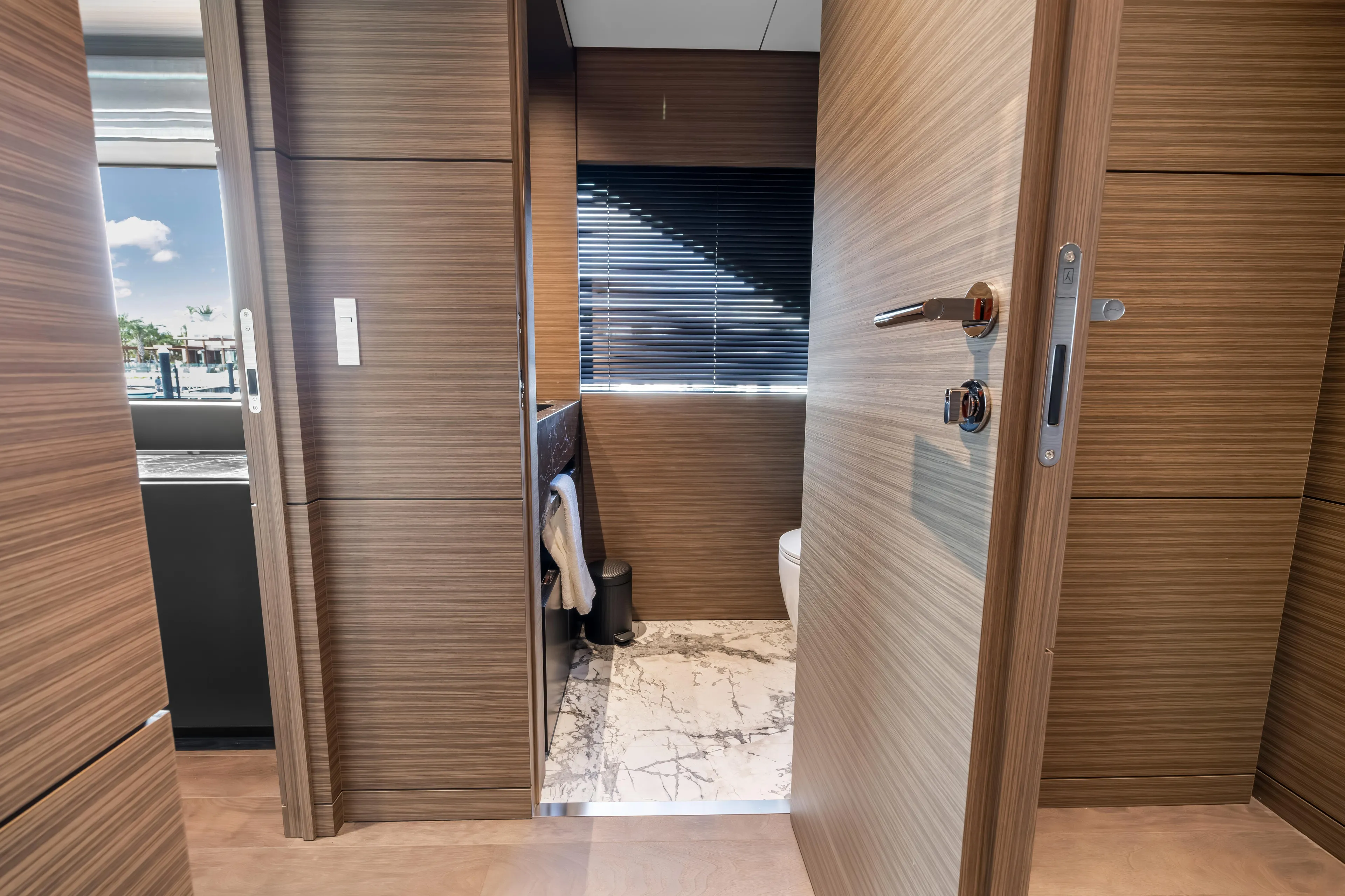 Navetta Yacht Photos Pics Luxurious 2023 Custom Line NAVETTA 42 yacht interior with modern wood paneling and marble flooring.