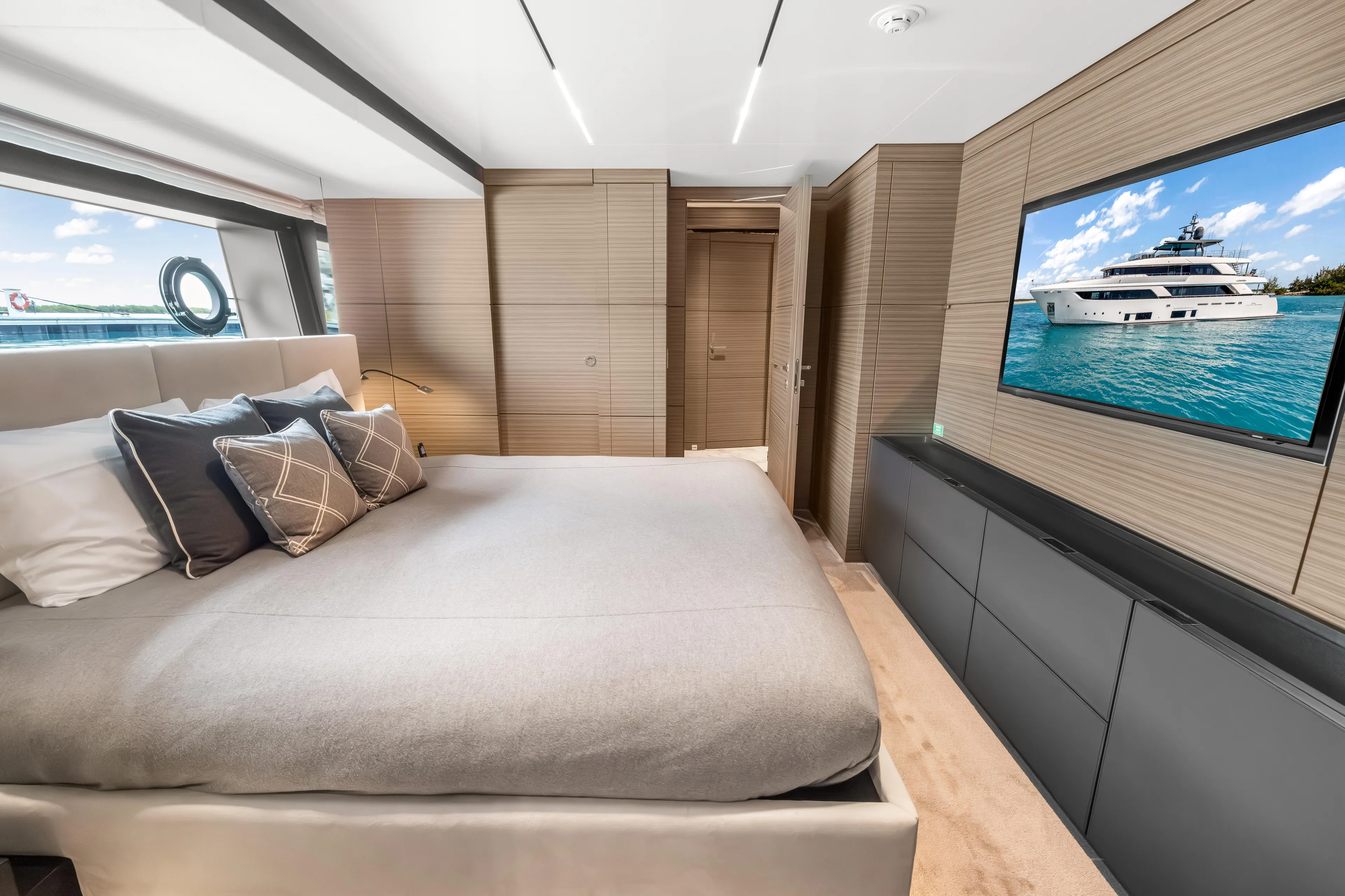 Navetta Yacht Photos Pics Luxurious bedroom interior of 2023 Custom Line NAVETTA 42 yacht with modern decor and ocean view.