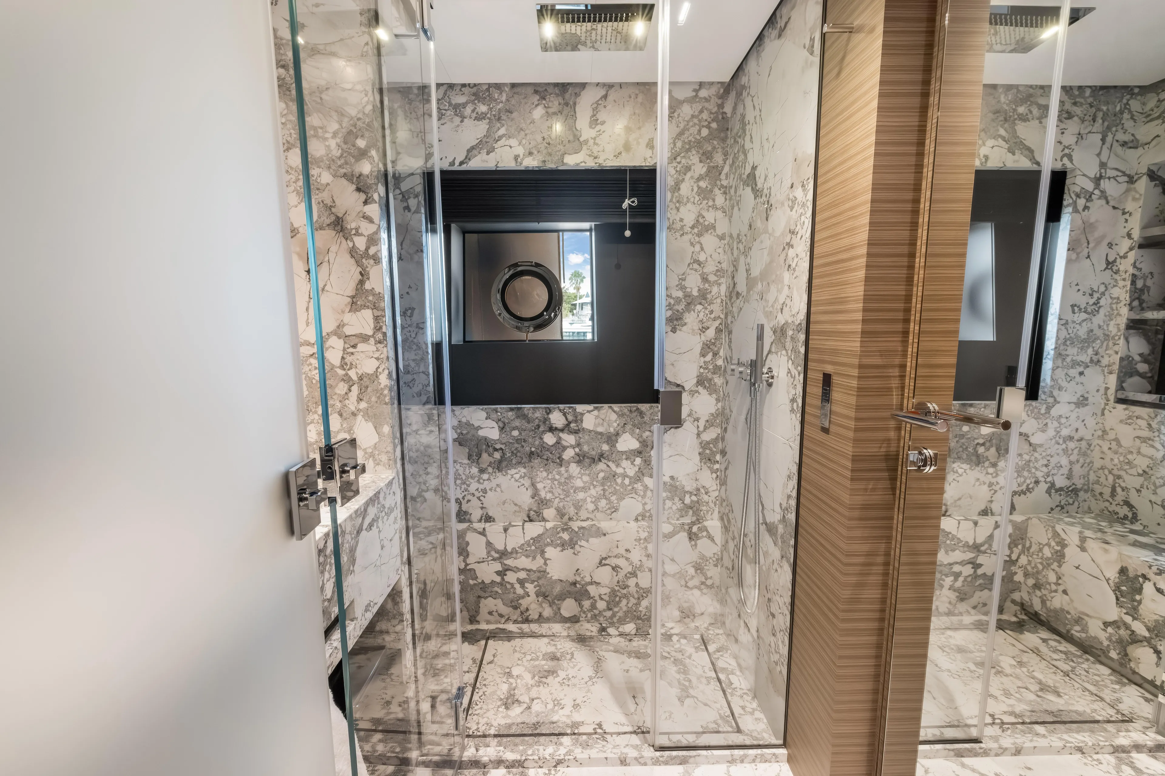 Navetta Yacht Photos Pics Luxurious marble bathroom in 2023 Custom Line NAVETTA 42 yacht, featuring modern shower design.