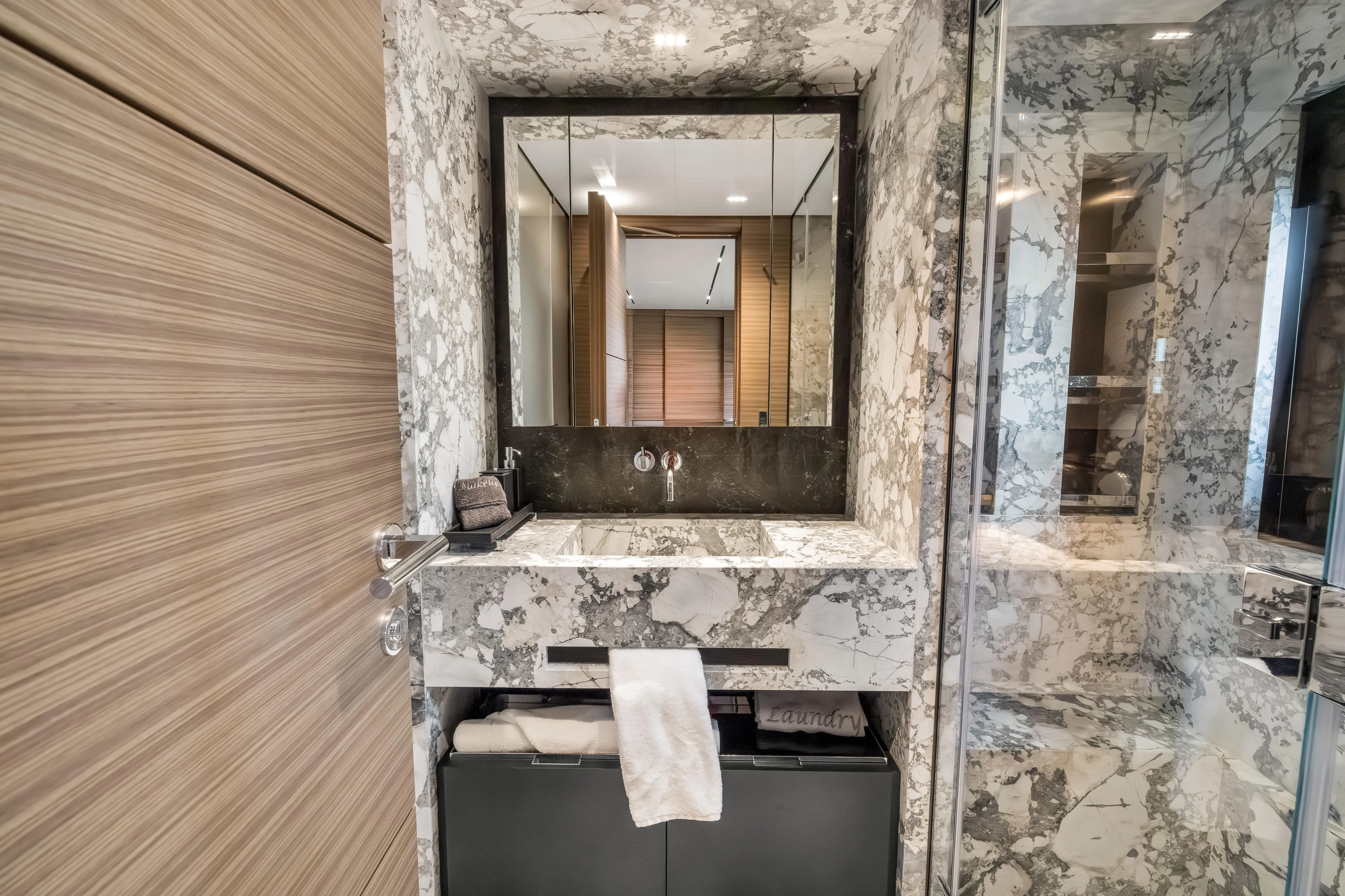 Navetta Yacht Photos Pics Luxurious marble bathroom in 2023 Custom Line NAVETTA 42 yacht, featuring modern sink and mirror.