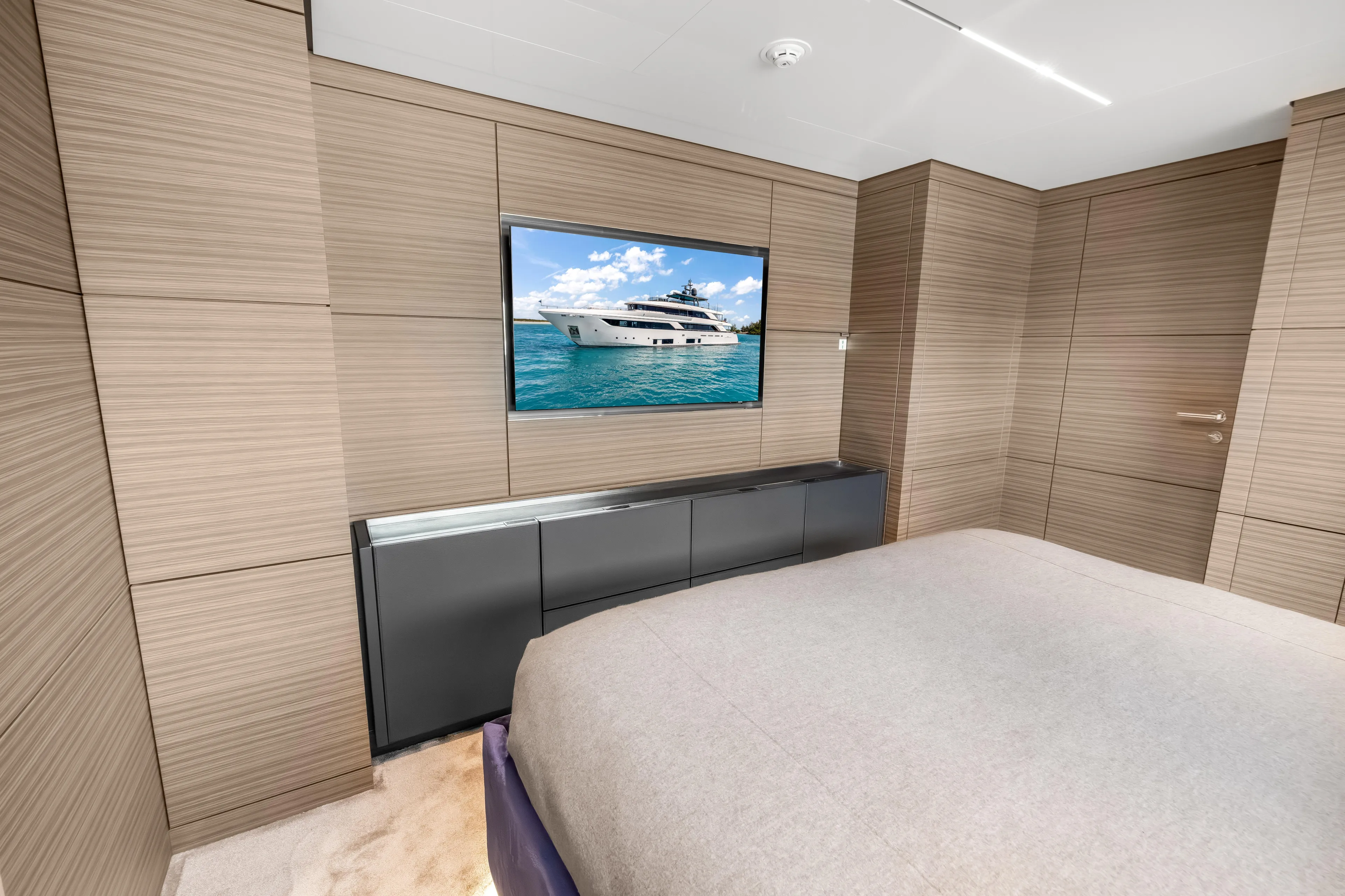 Navetta Yacht Photos Pics Luxurious bedroom interior of 2023 Custom Line NAVETTA 42 yacht with modern wood paneling.