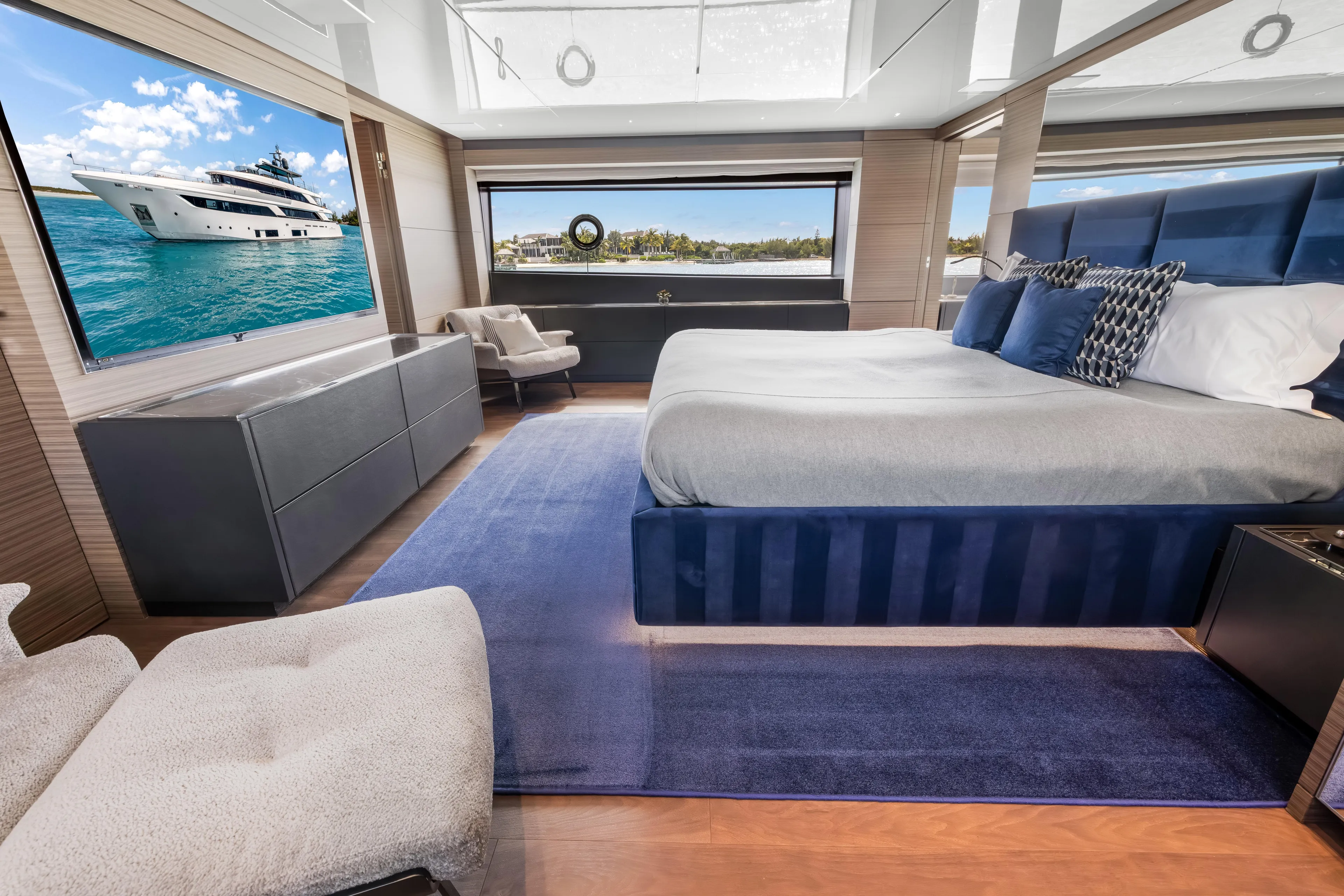 Navetta Yacht Photos Pics Luxurious 2023 Custom Line NAVETTA 42 yacht bedroom with modern decor and ocean view.