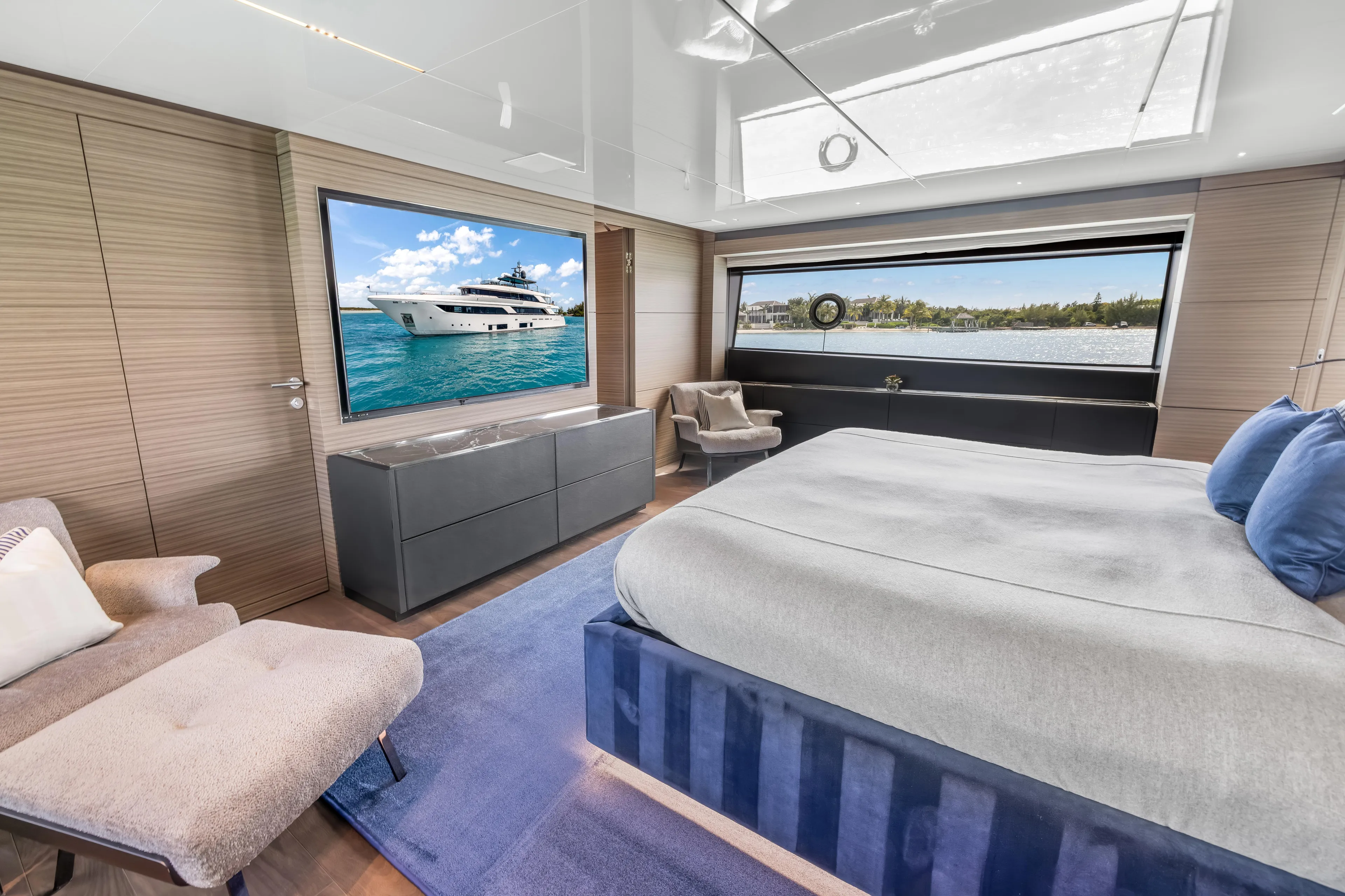 Navetta Yacht Photos Pics Luxurious 2023 Custom Line NAVETTA 42 yacht bedroom with modern decor and scenic window view.