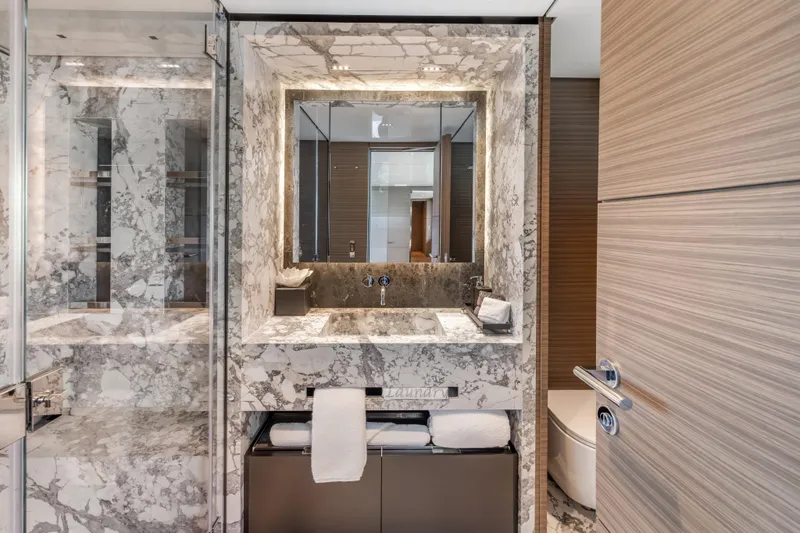 Navetta Yacht Photos Pics Luxurious marble bathroom in 2023 Custom Line NAVETTA 42 yacht, featuring modern fixtures and elegant design.