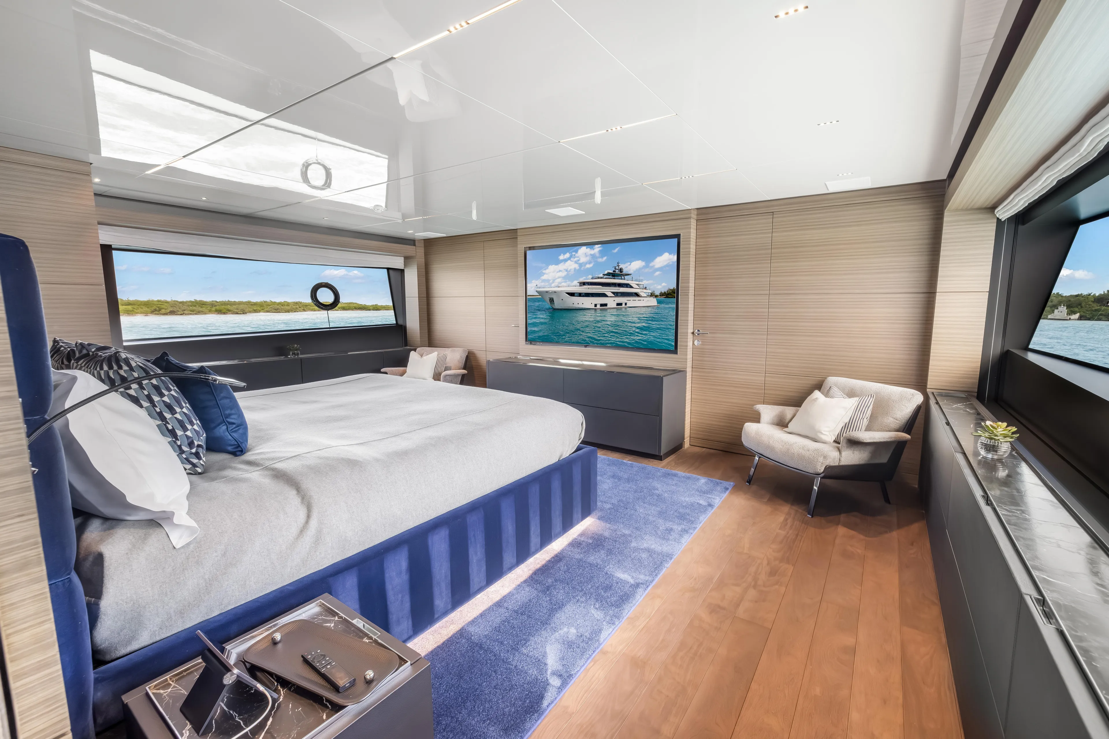 Navetta Yacht Photos Pics Luxurious 2023 Custom Line NAVETTA 42 yacht bedroom with modern decor and scenic ocean views.