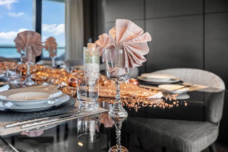 Navetta Yacht Photos Pics Luxurious dining setup on Custom Line NAVETTA 42 yacht, 2023 model, with elegant tableware.