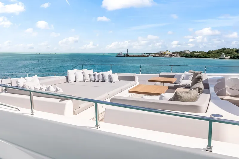 Navetta Yacht Photos Pics Luxurious 2023 Custom Line NAVETTA 42 yacht deck with ocean view and plush seating.