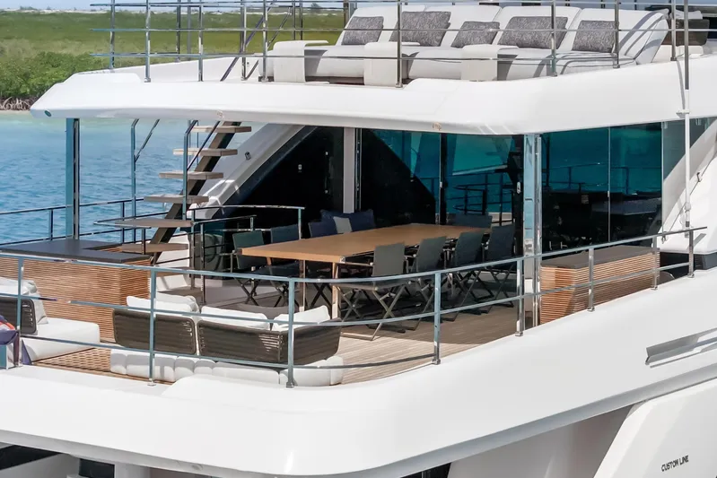 Navetta Yacht Photos Pics Luxurious 2023 Custom Line NAVETTA 42 yacht with spacious outdoor seating and dining area.