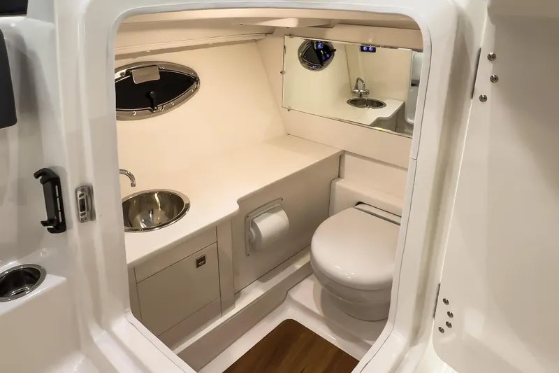  Yacht Photos Pics 2026 Robalo R277 Dual Console boat bathroom with sink, toilet, and mirror.