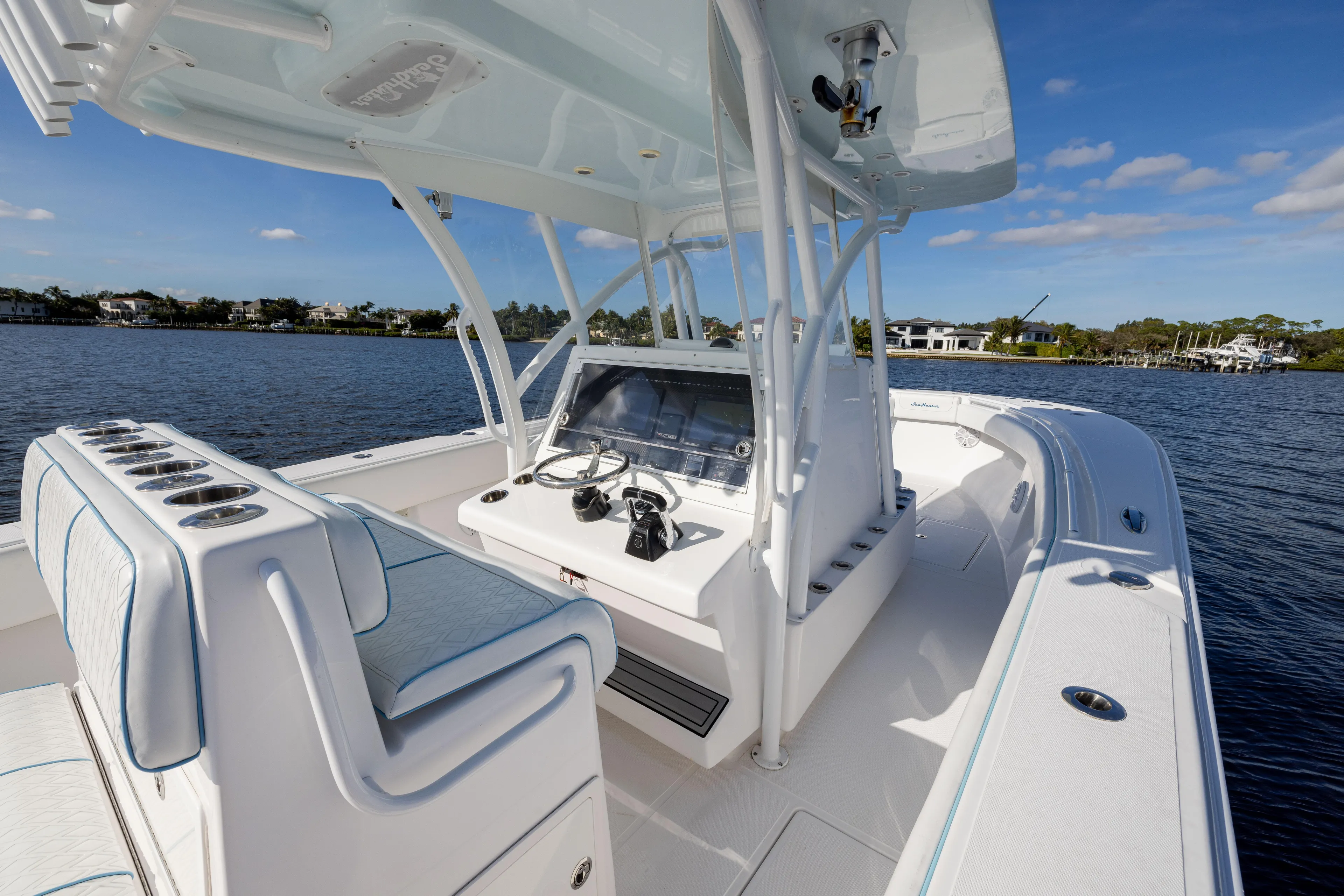 Bloodline Yacht Photos Pics 2018 SeaHunter 33' Center Console boat on calm water, featuring a sleek helm and seating.