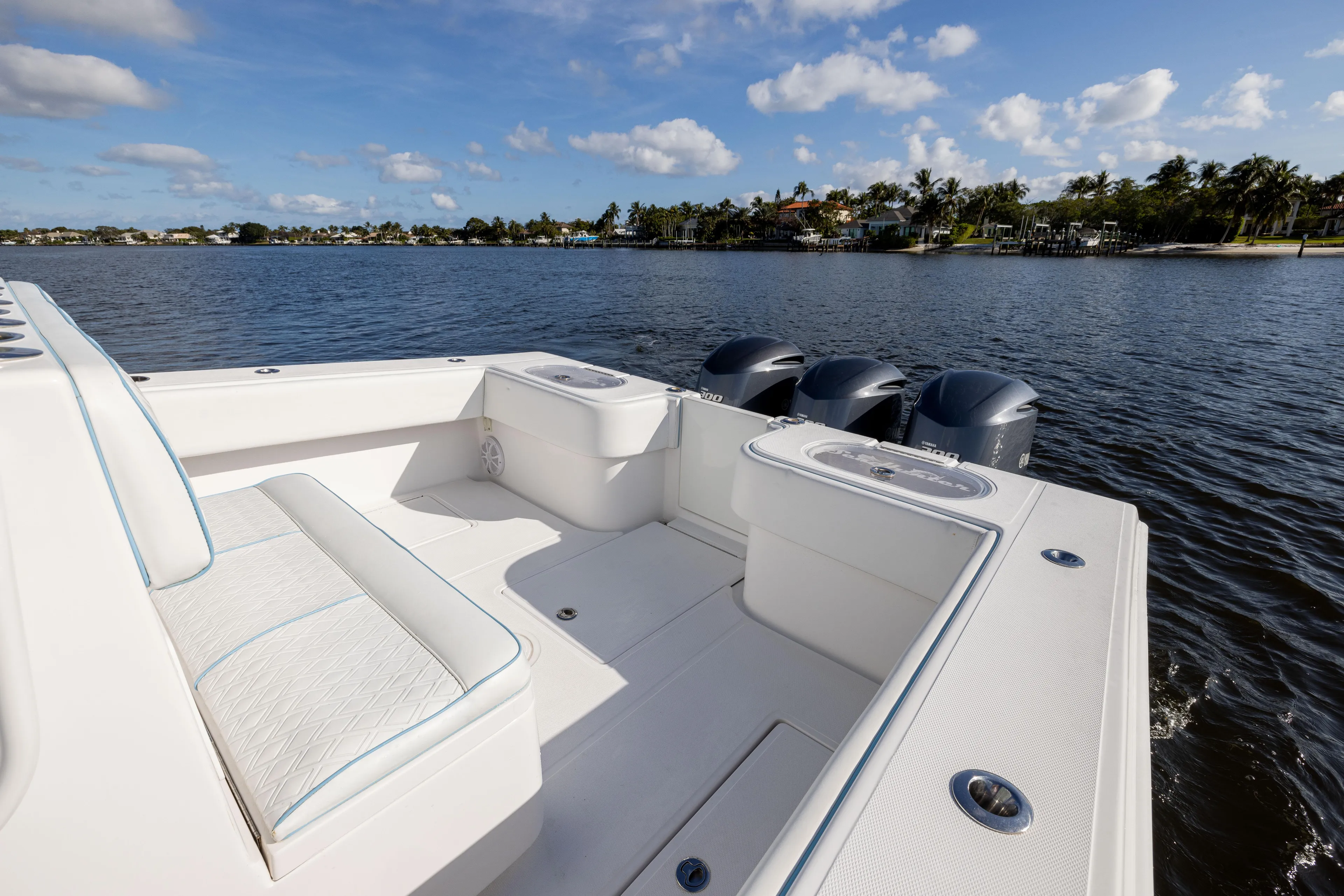 Bloodline Yacht Photos Pics 2018 SeaHunter 33' Center Console boat on calm water, featuring spacious seating and triple engines.