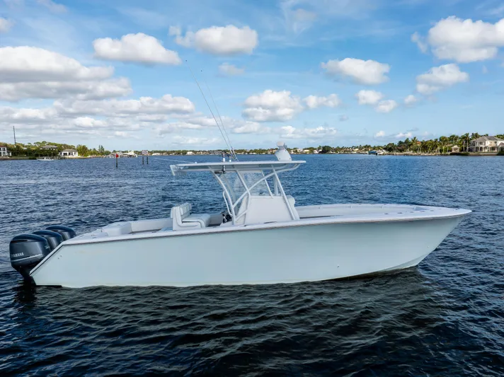 Bloodline Yacht Photos Pics 2018 SeaHunter 33' Center Console boat on calm water under blue sky.