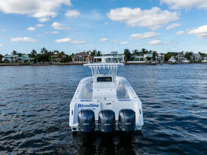 Bloodline Yacht Photos Pics 2018 SeaHunter 33' Center Console boat with triple engines on a calm waterway.