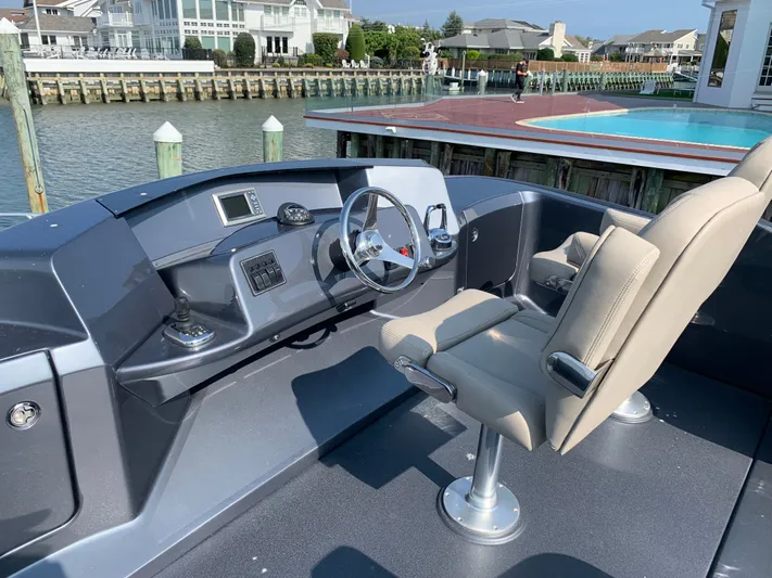  Yacht Photos Pics Silverton 4100 SC yacht helm, 2019 model, docked by water.