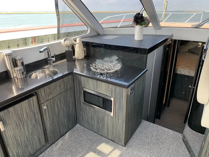  Yacht Photos Pics Interior of Silverton 4100 SC yacht, modern kitchen with microwave.