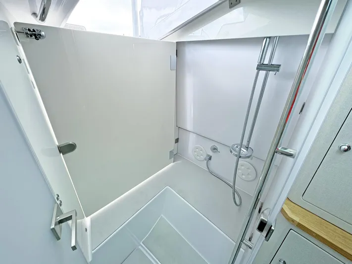  Yacht Photos Pics 2024 Axopar 37 Sun Top boat shower area with modern fixtures and sleek design.