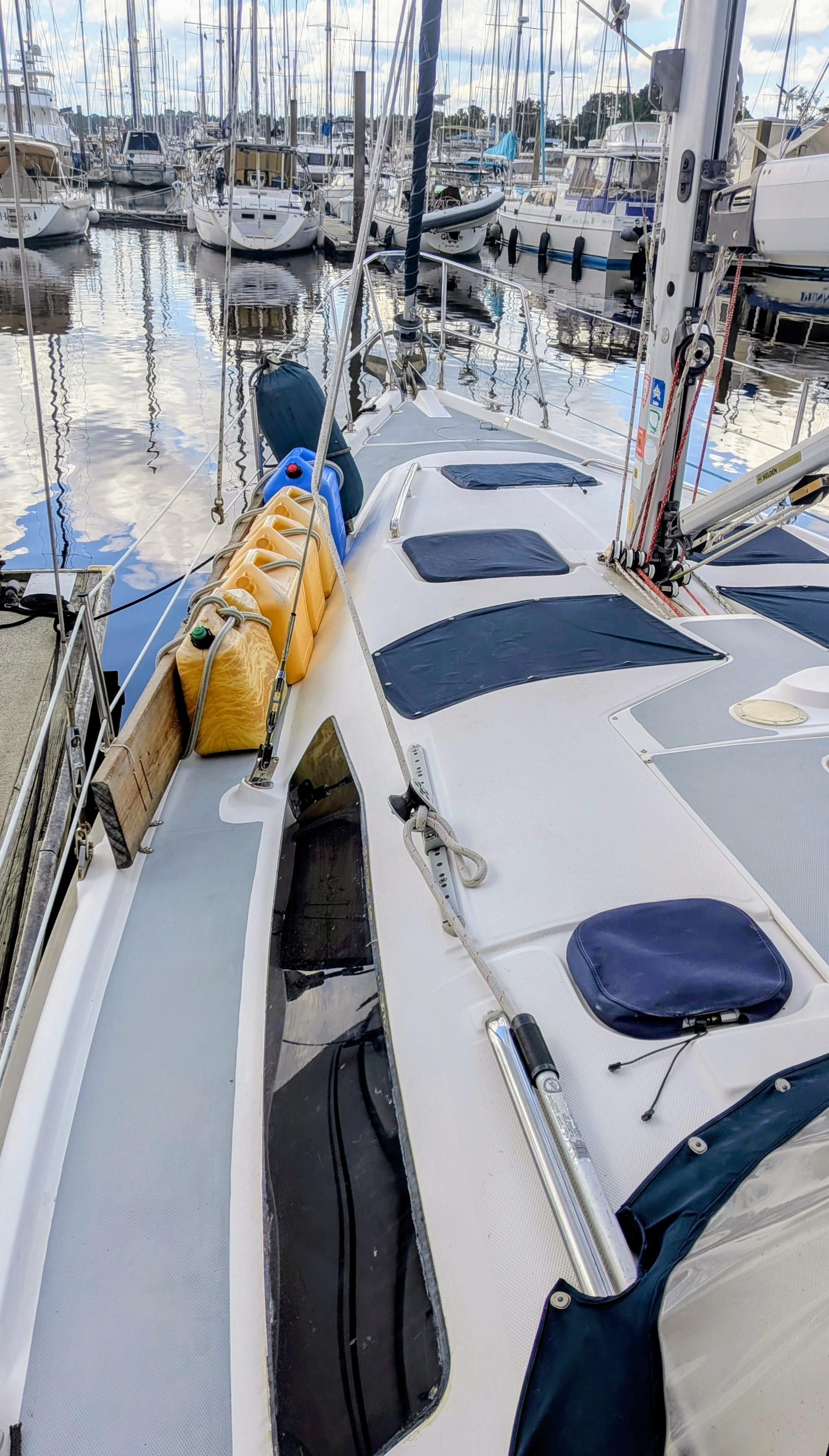 2001 Hunter 380 sailboat docked at marina with other boats in background.