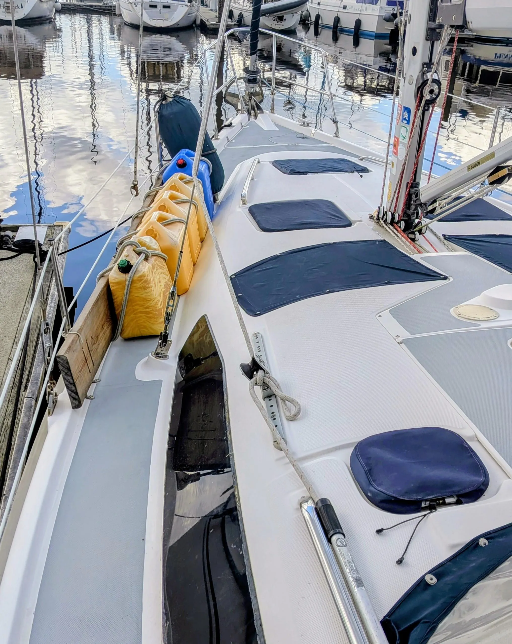 2001 Hunter 380 sailboat docked at marina with other boats in background.