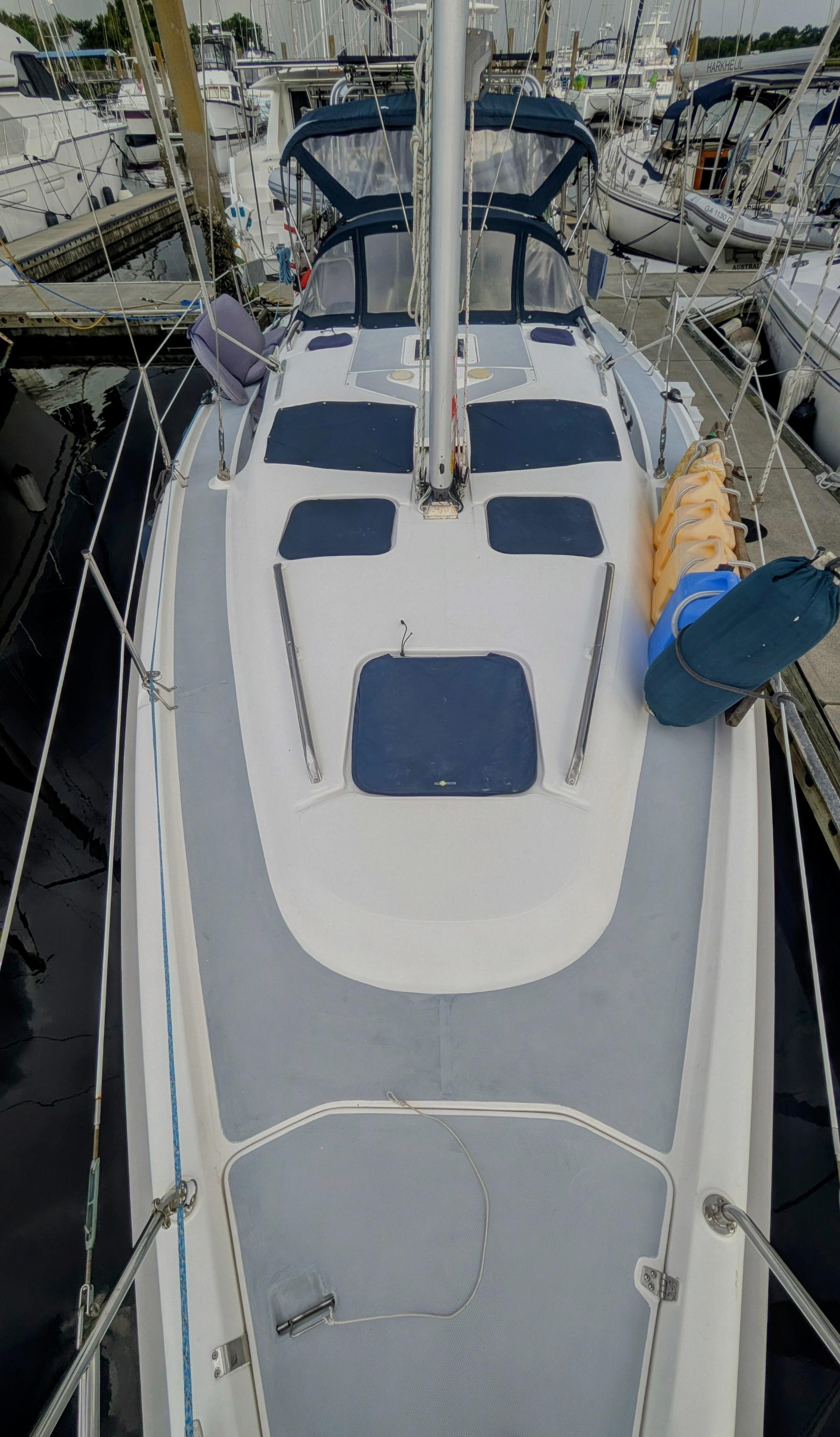 Sailboat deck of 2001 Hunter 380, docked in marina, top view.