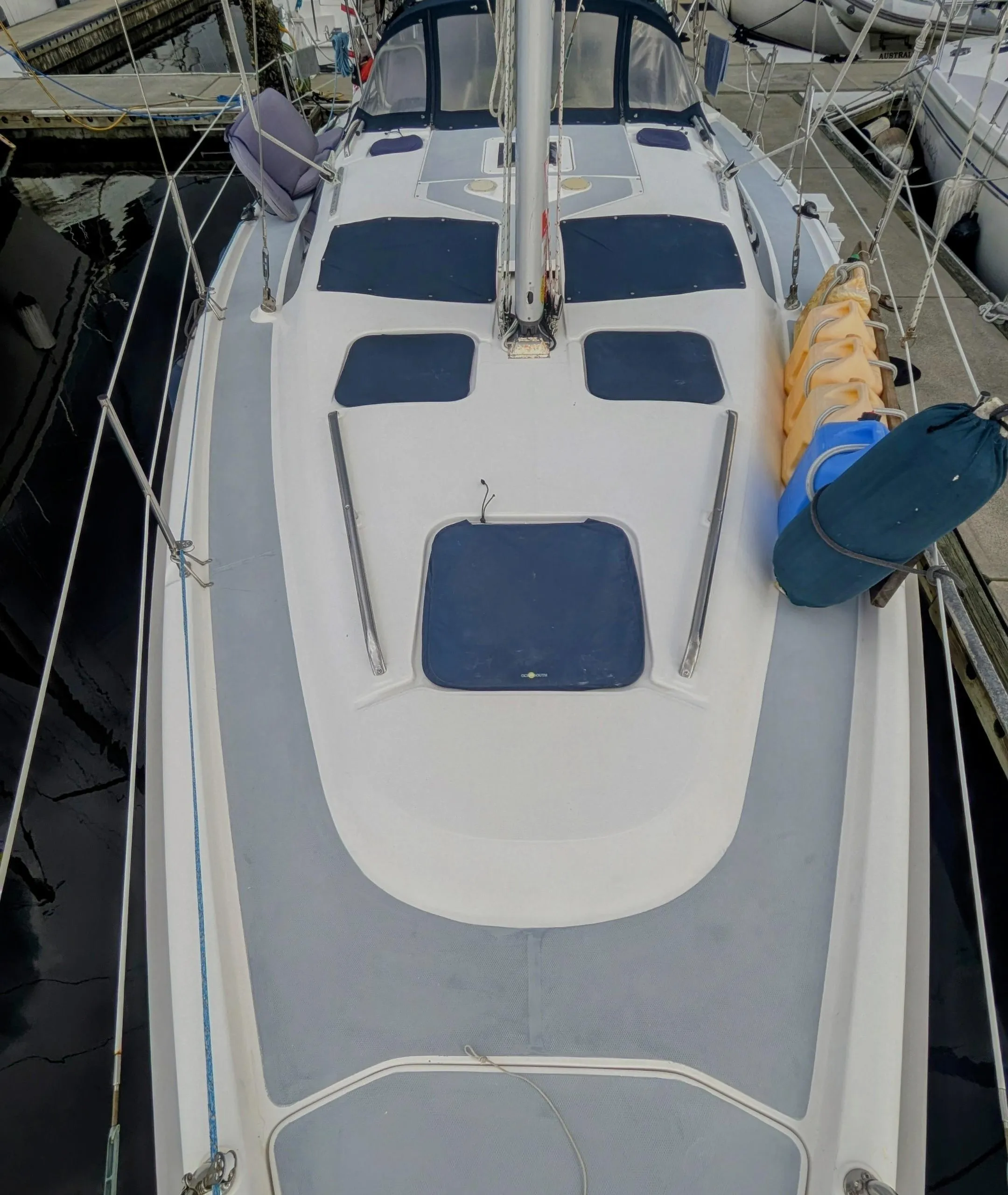 Sailboat deck of 2001 Hunter 380, docked in marina, top view.