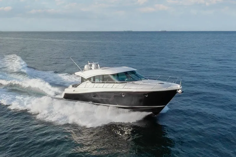 Happy Daze IV Yacht Photos Pics 2017 Tiara Yachts C53 Coupe cruising on open water, showcasing sleek design and performance.