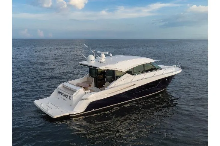 Happy Daze IV Yacht Photos Pics 2017 Tiara Yachts C53 Coupe cruising on open water under a clear sky.