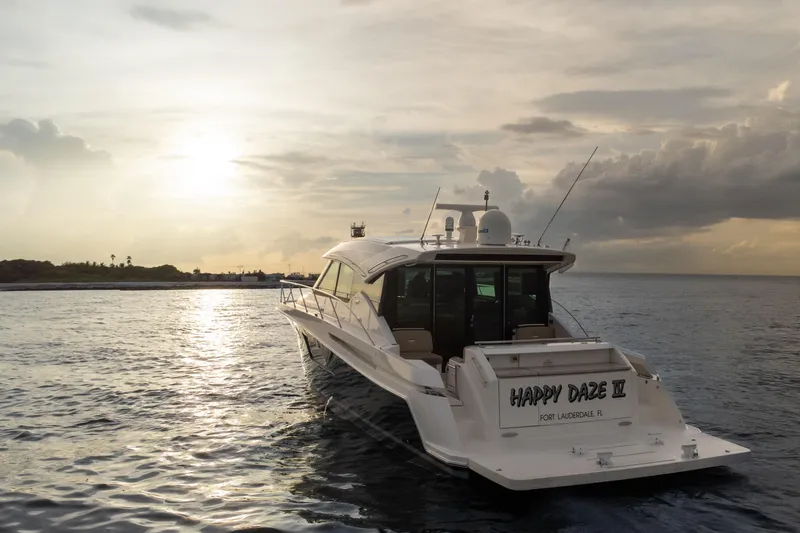 Happy Daze IV Yacht Photos Pics 2017 Tiara Yachts C53 Coupe at sunset on calm waters.