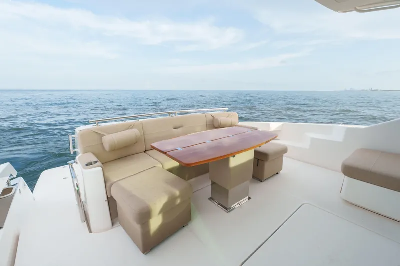 Happy Daze IV Yacht Photos Pics Luxurious seating area on 2017 Tiara Yachts C53 Coupe, overlooking the ocean.